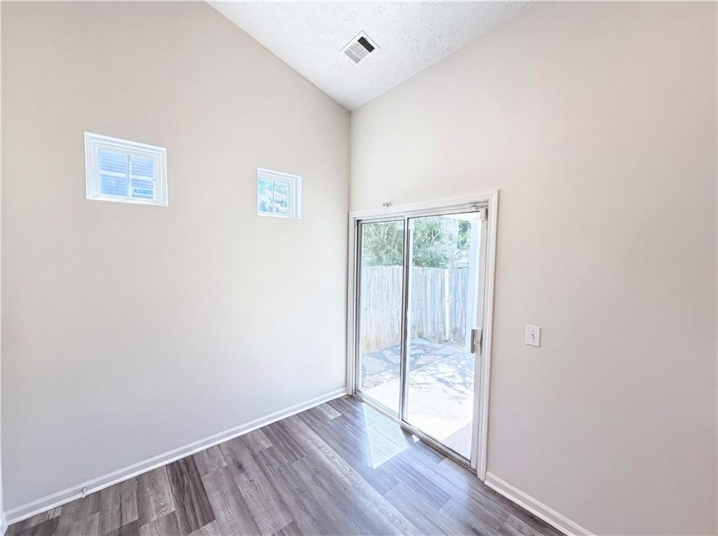 503 Oakleaf Court Acworth, GA 30102 - Photo 13 of 17 an empty room with wooden floor and windows