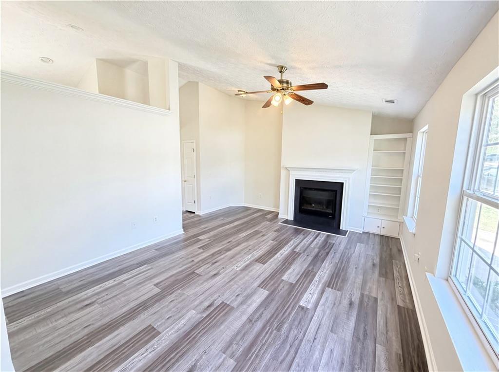 503 Oakleaf Court Acworth, GA 30102 - Photo 2 of 17 wooden floor in an empty room with a fireplace