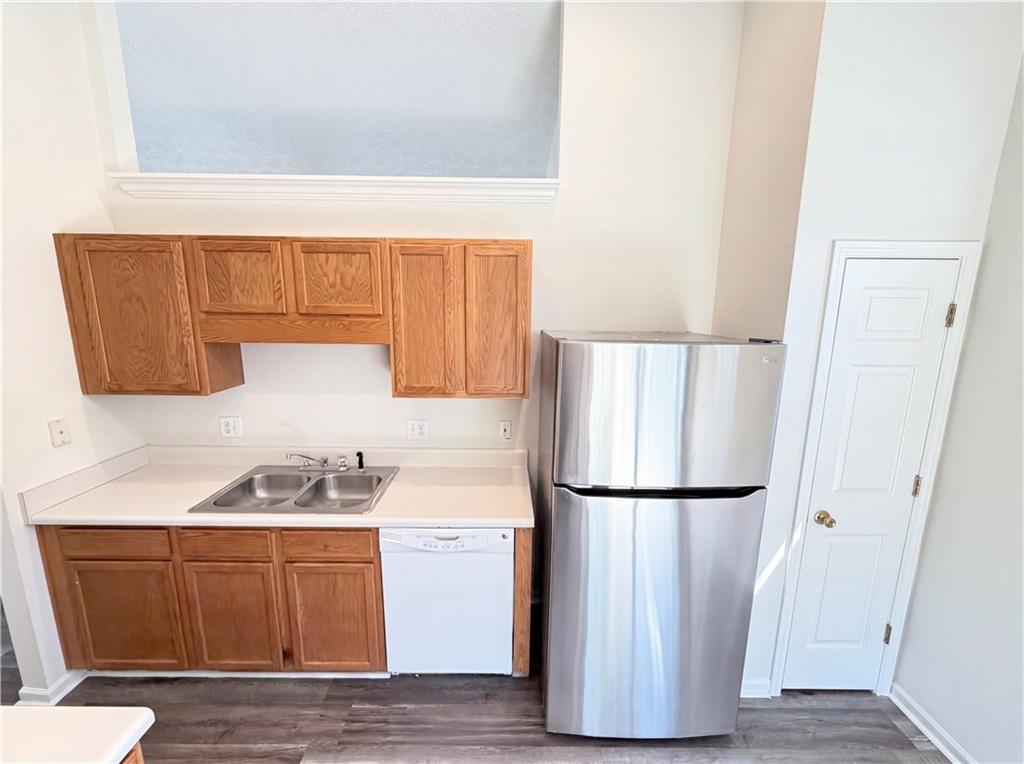 503 Oakleaf Court Acworth, GA 30102 - Photo 5 of 17 a kitchen with wooden cabinets and a refrigerator