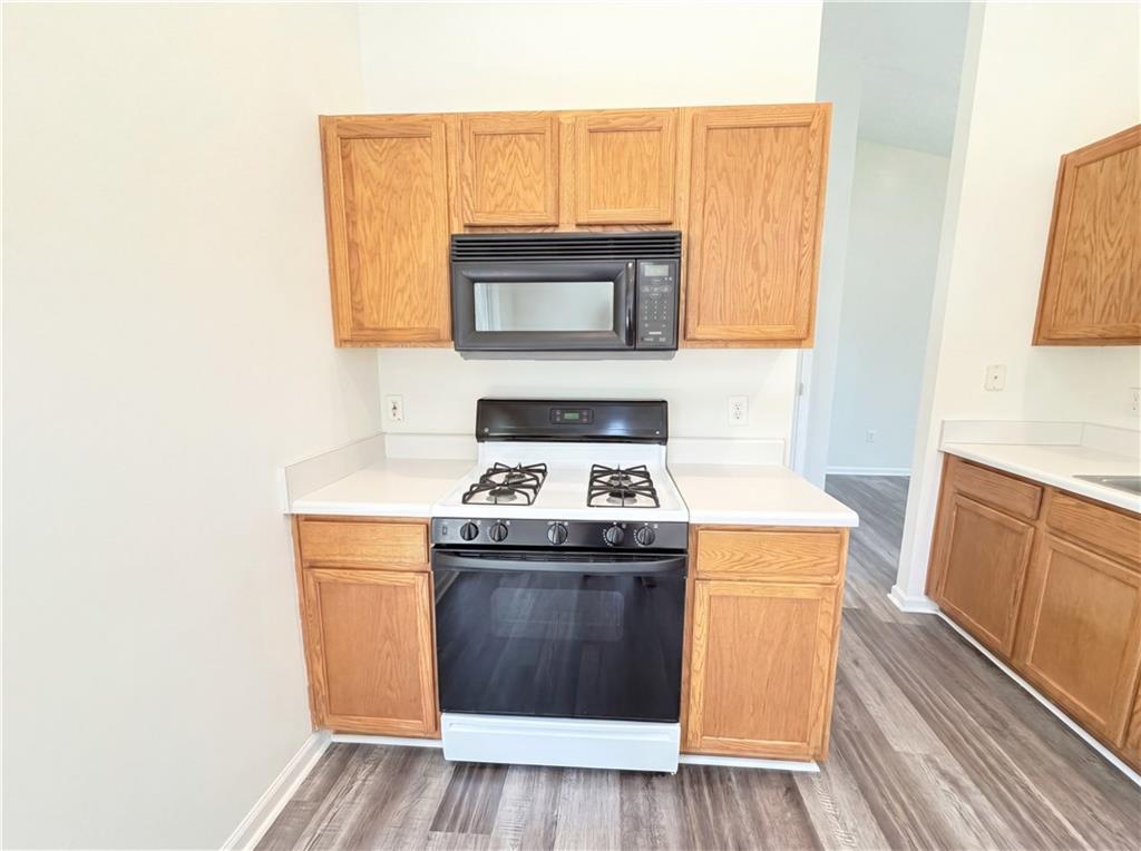 503 Oakleaf Court Acworth, GA 30102 - Photo 6 of 17 a kitchen with granite countertop a stove and a sink