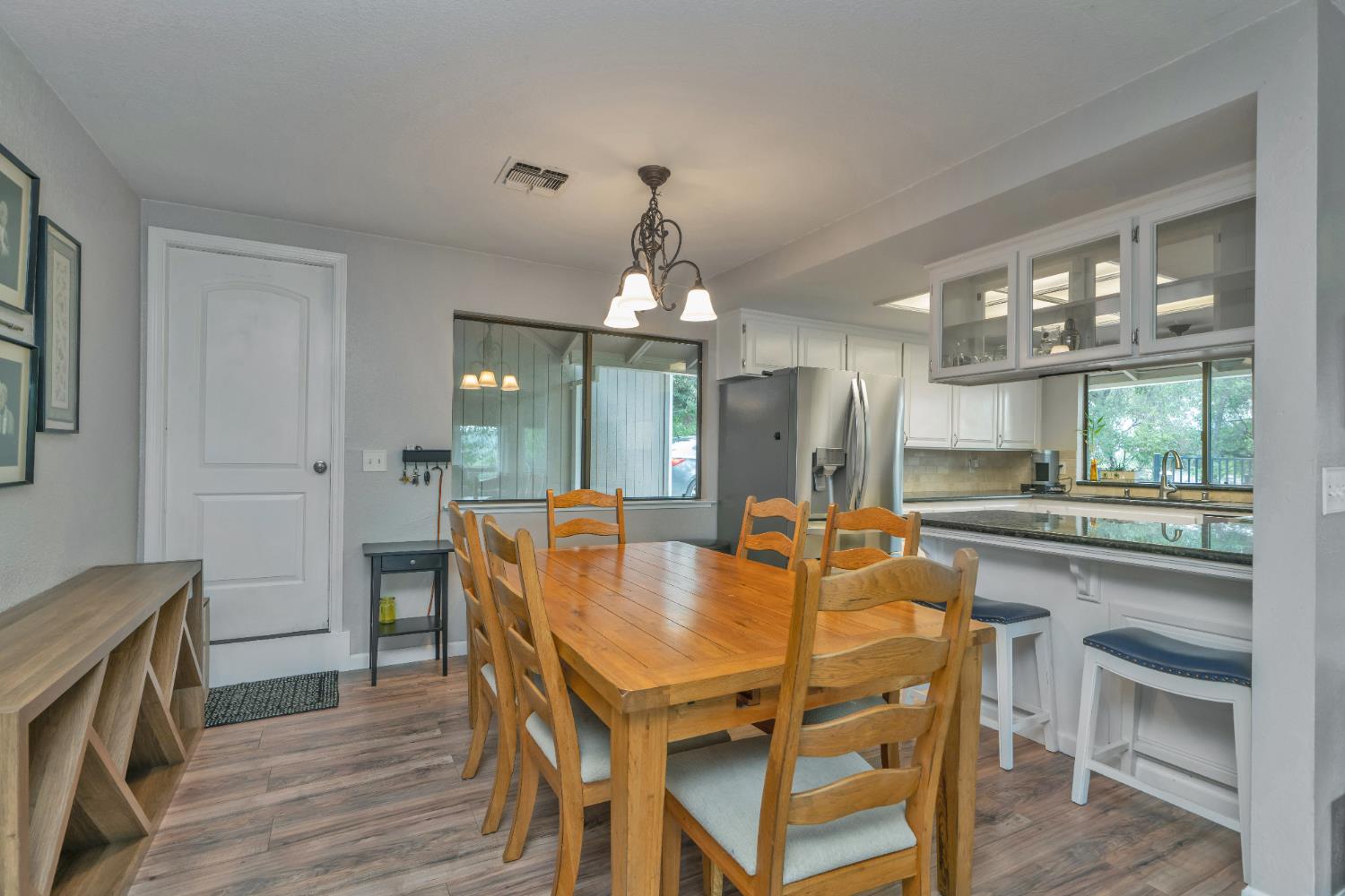 3041 Rising Hill Court Placerville, CA 95667 - Photo 11 of 31 a dining room with furniture a chandelier and wooden floor