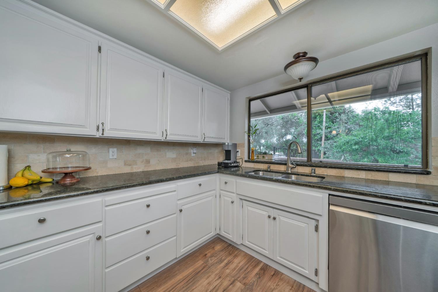 3041 Rising Hill Court Placerville, CA 95667 - Photo 30 of 31 a kitchen with granite countertop white cabinets and a window