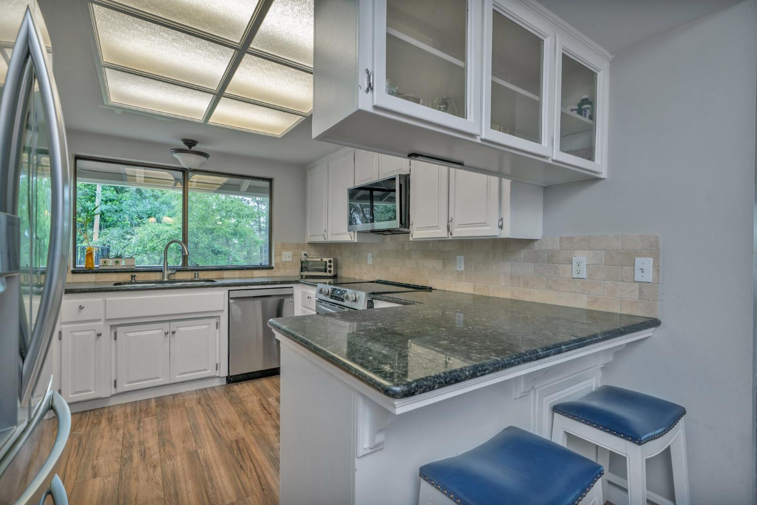 3041 Rising Hill Court Placerville, CA 95667 - Photo 3 of 31 a kitchen with stainless steel appliances granite countertop a sink stove and cabinets