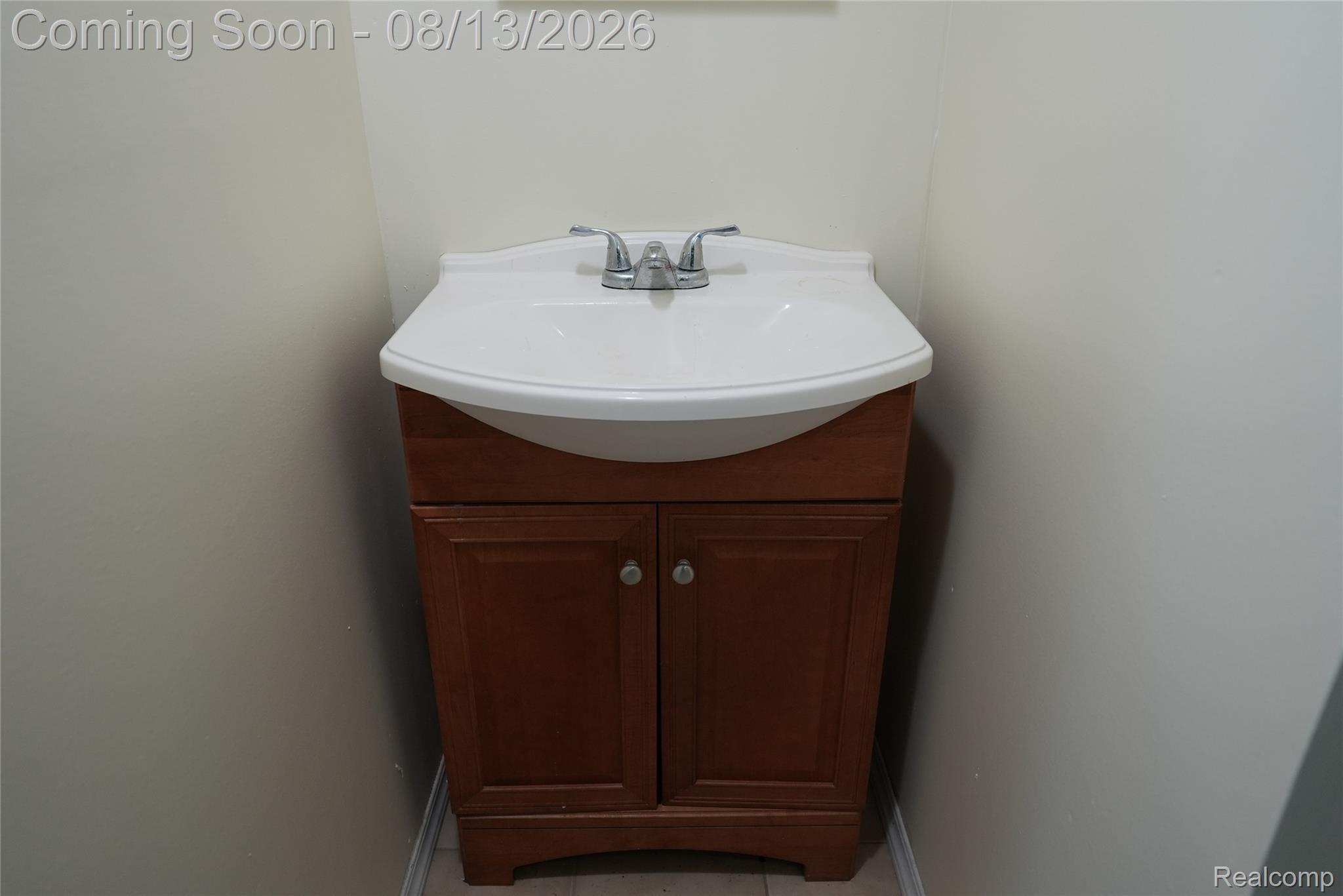 2018 John R Road Troy, MI 48083 - Photo 25 of 57 Wood-finish vanity with a white integrated sink and chrome faucet