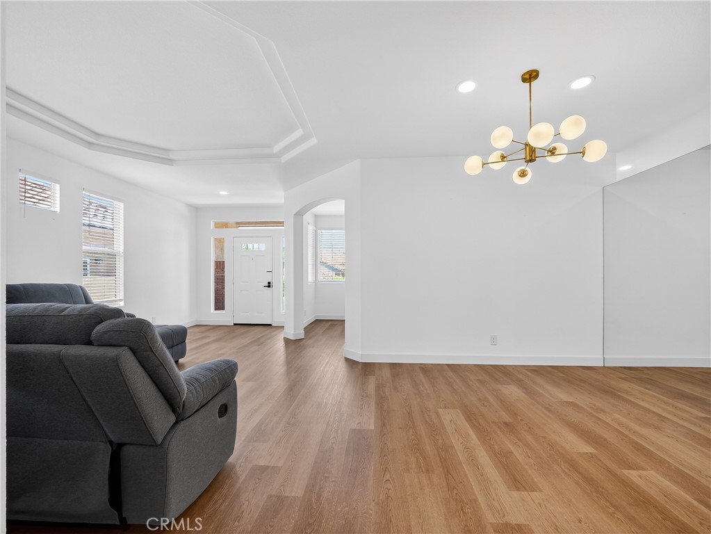 1436 Riviera Avenue Banning, CA 92220 - Photo 14 of 43 a living room with furniture and a chandelier