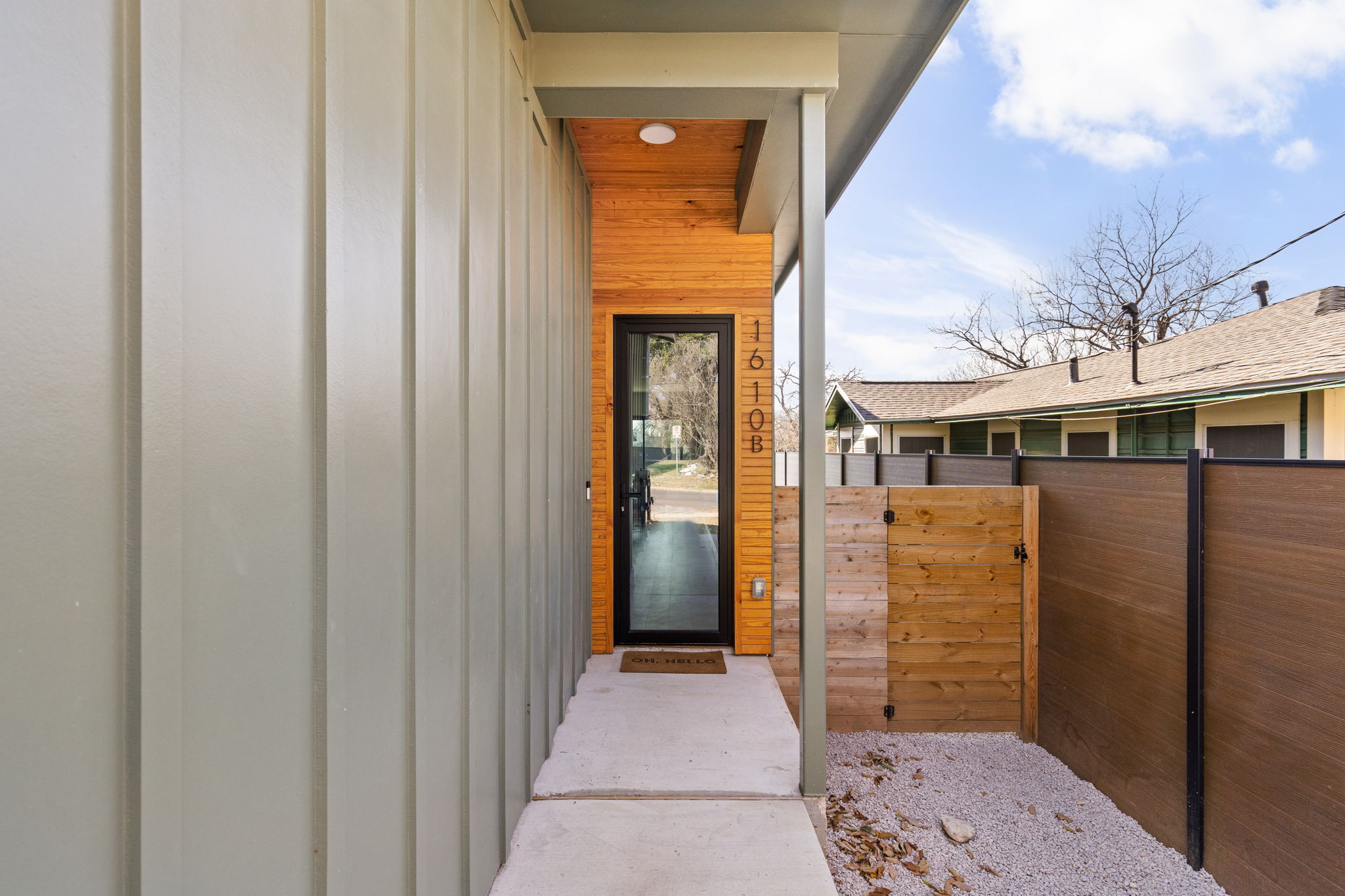 1610 Harvey Street, Unit 1 Austin, TX 78702 - Photo 5 of 39 Doorway to property featuring a gate and board and batten siding