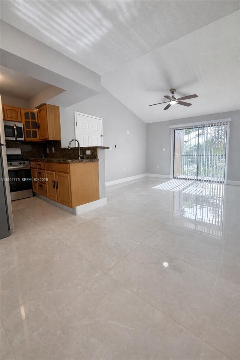 10581 Southwest 155th Court, Unit 1222 Miami, FL 33196 - Photo 5 of 15 an empty room with furniture and windows