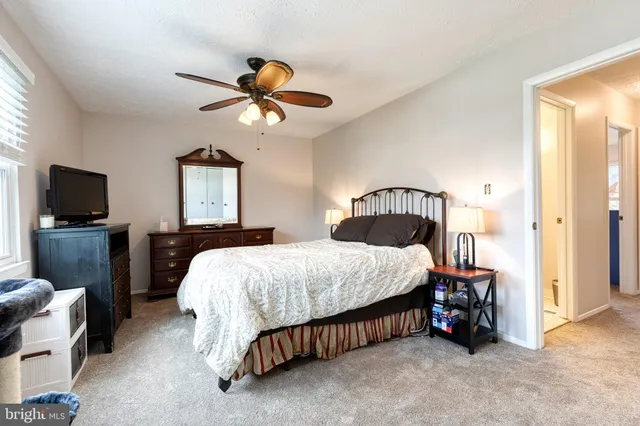 a bedroom with a bed and a television