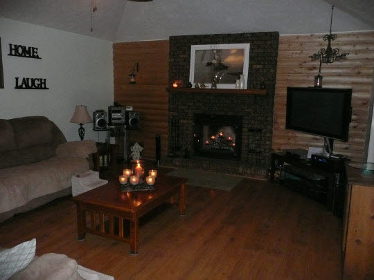 5712 Gray Eagle Road Roscoe, IL 61073 - Photo 8 of 10 a living room with furniture a flat screen tv and a fireplace