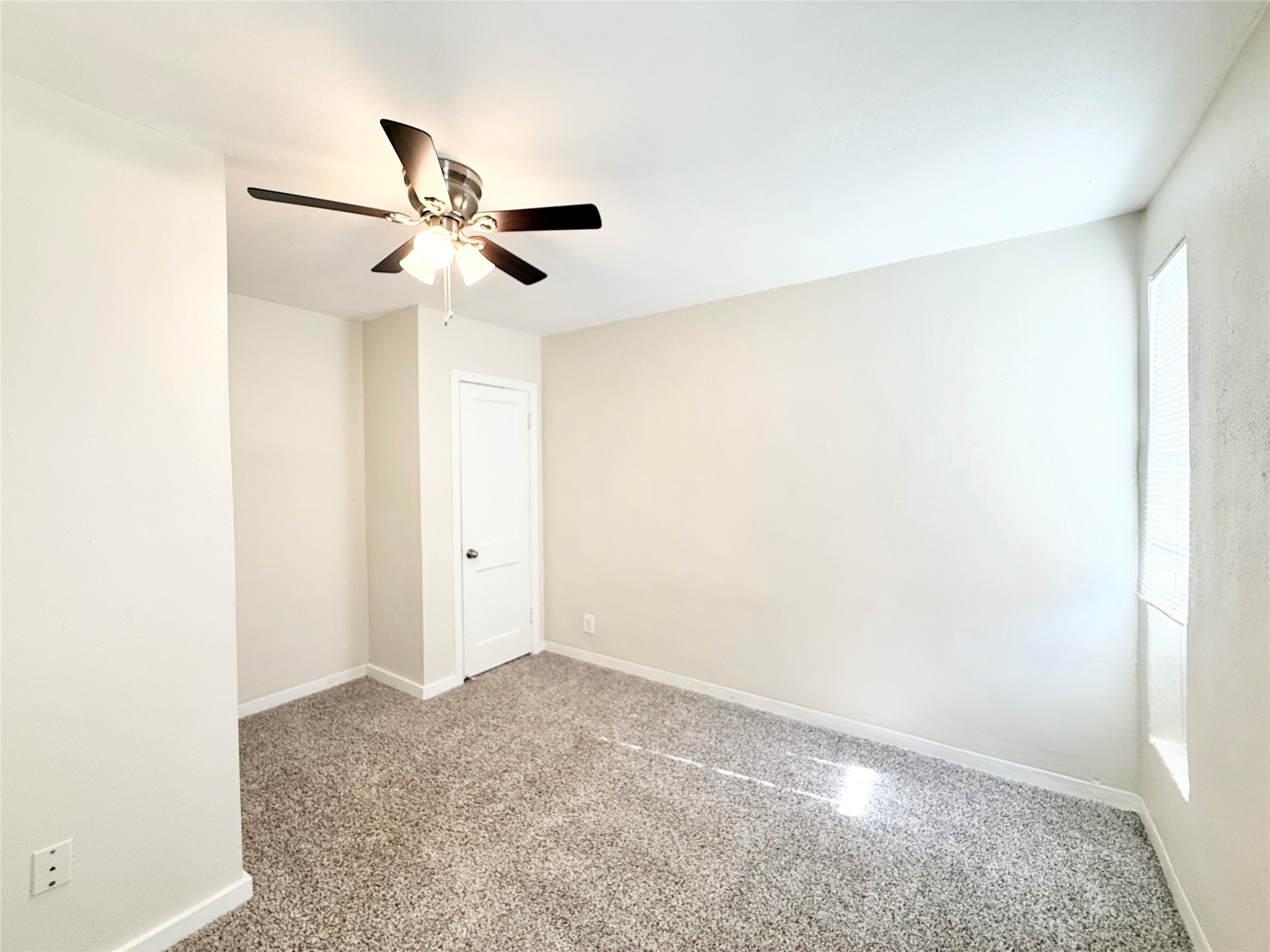 2717 Hadley Street, Unit 16 Houston, TX 77004 - Photo 11 of 27 a view of a room with a ceiling fan and carpet