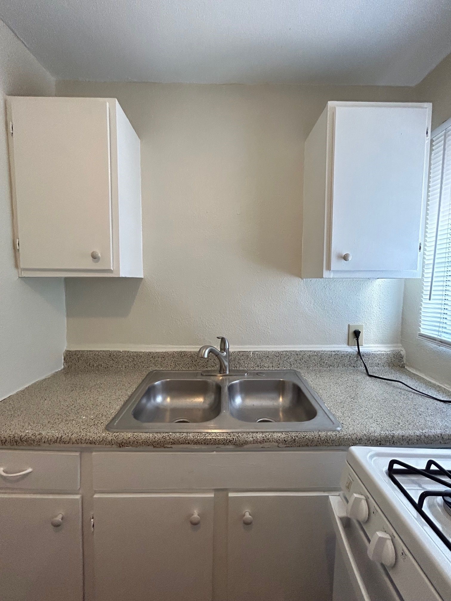 2717 Hadley Street, Unit 16 Houston, TX 77004 - Photo 19 of 27 a kitchen with granite countertop a sink a stove and cabinets