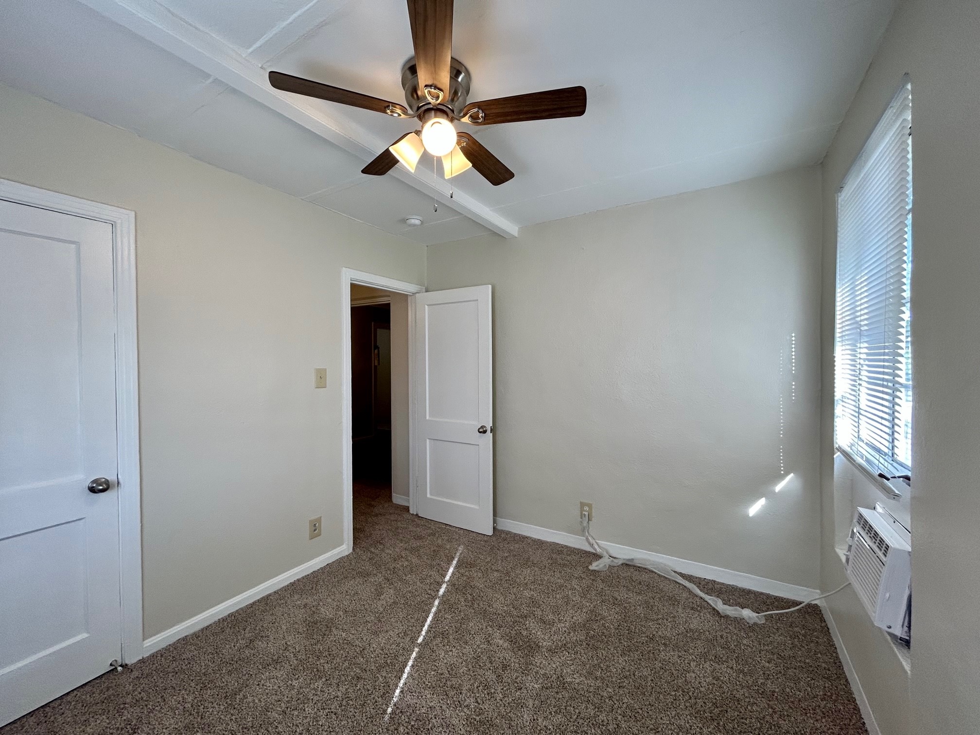 2717 Hadley Street, Unit 16 Houston, TX 77004 - Photo 22 of 27 an empty room with chandelier fan and windows