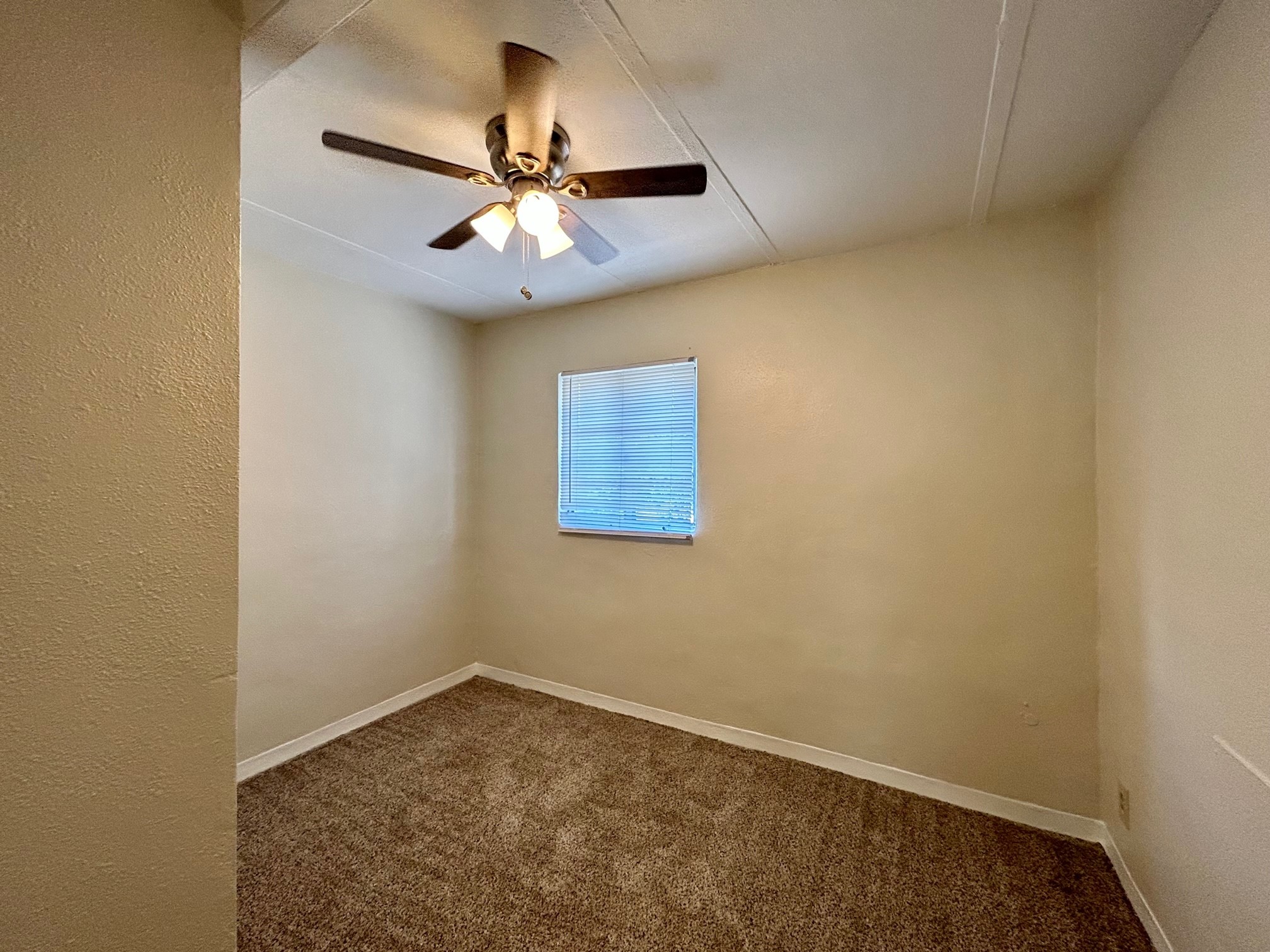 2717 Hadley Street, Unit 16 Houston, TX 77004 - Photo 24 of 27 an empty room with a window and a fan