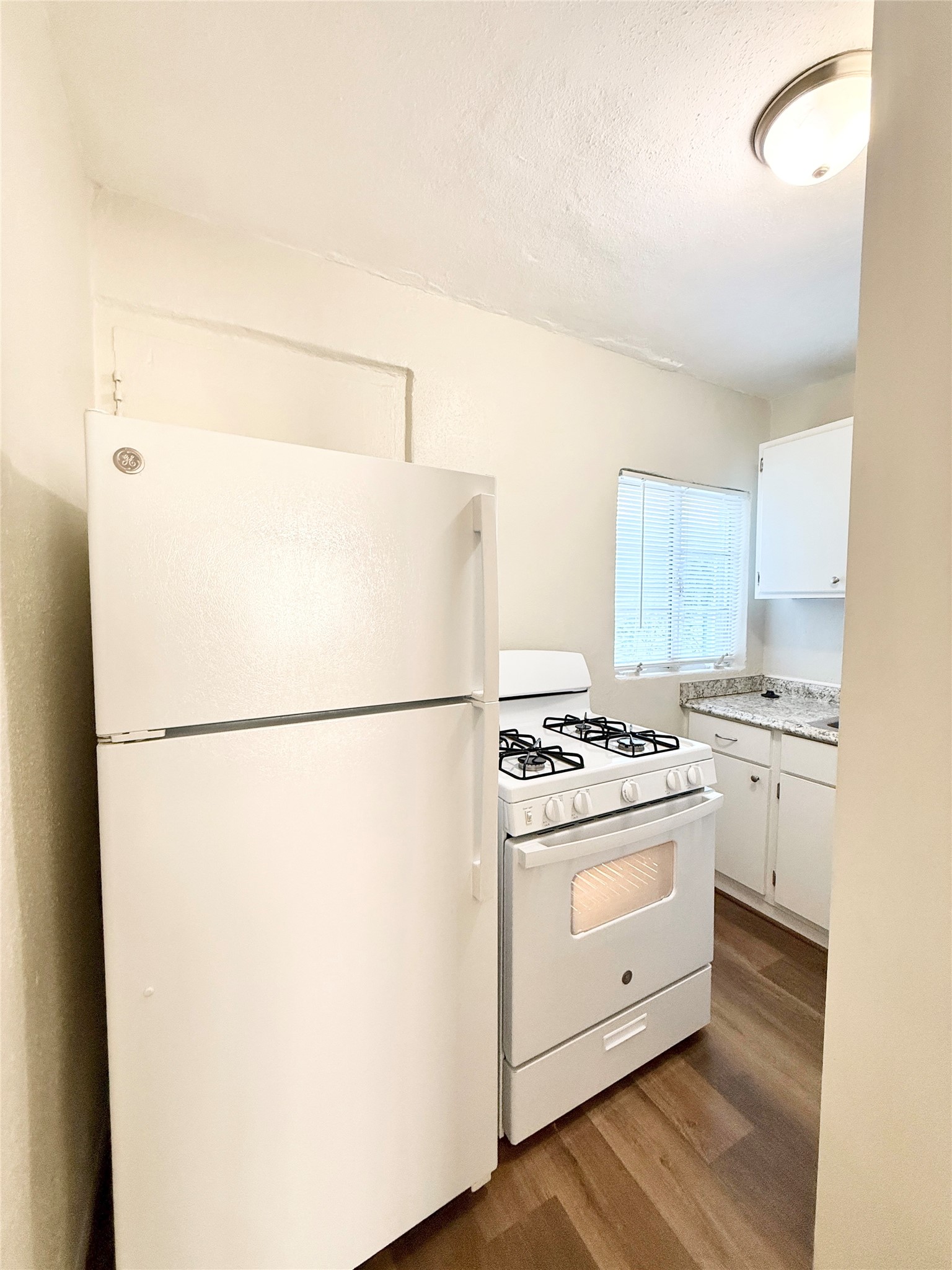 2717 Hadley Street, Unit 16 Houston, TX 77004 - Photo 5 of 27 a white refrigerator freezer and a stove sitting inside of a kitchen