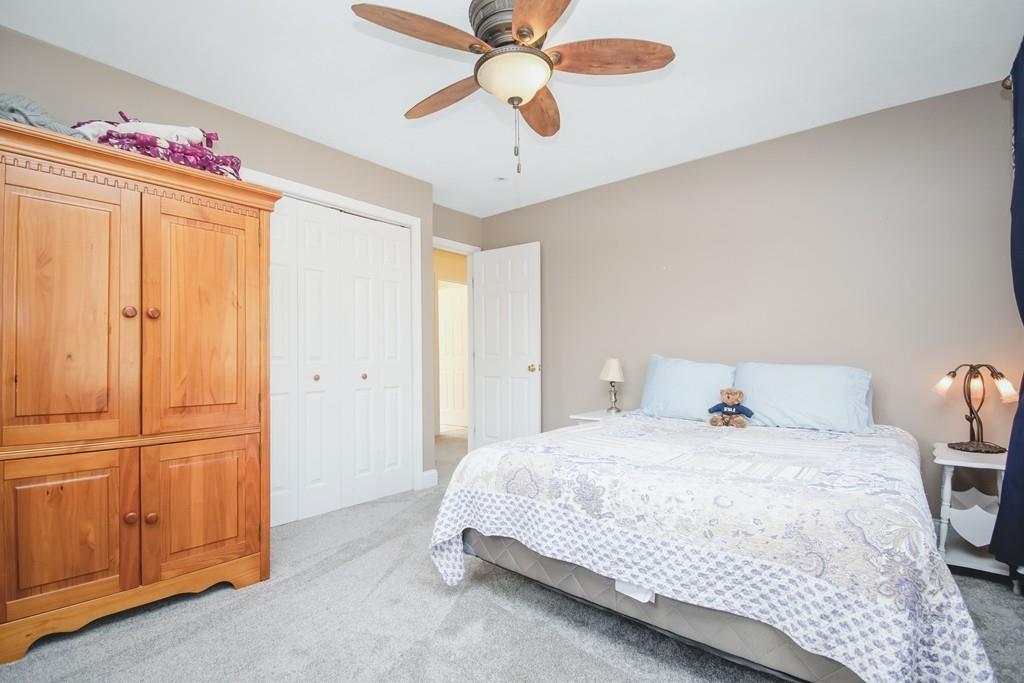 602 Southbridge Road Warren, MA 01083 - Photo 31 of 42 a bedroom with a bed and a chandelier