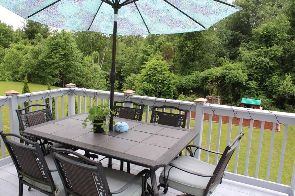602 Southbridge Road Warren, MA 01083 - Photo 5 of 42 a view of a balcony with furniture and umbrella