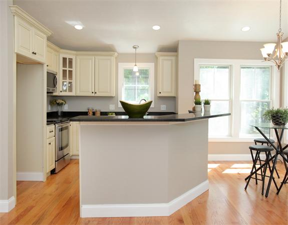 7 Lake Road Wellesley, MA 02482 - Photo 8 of 24 a kitchen with stainless steel appliances granite countertop a refrigerator a sink a stove and white cabinets with wooden floor