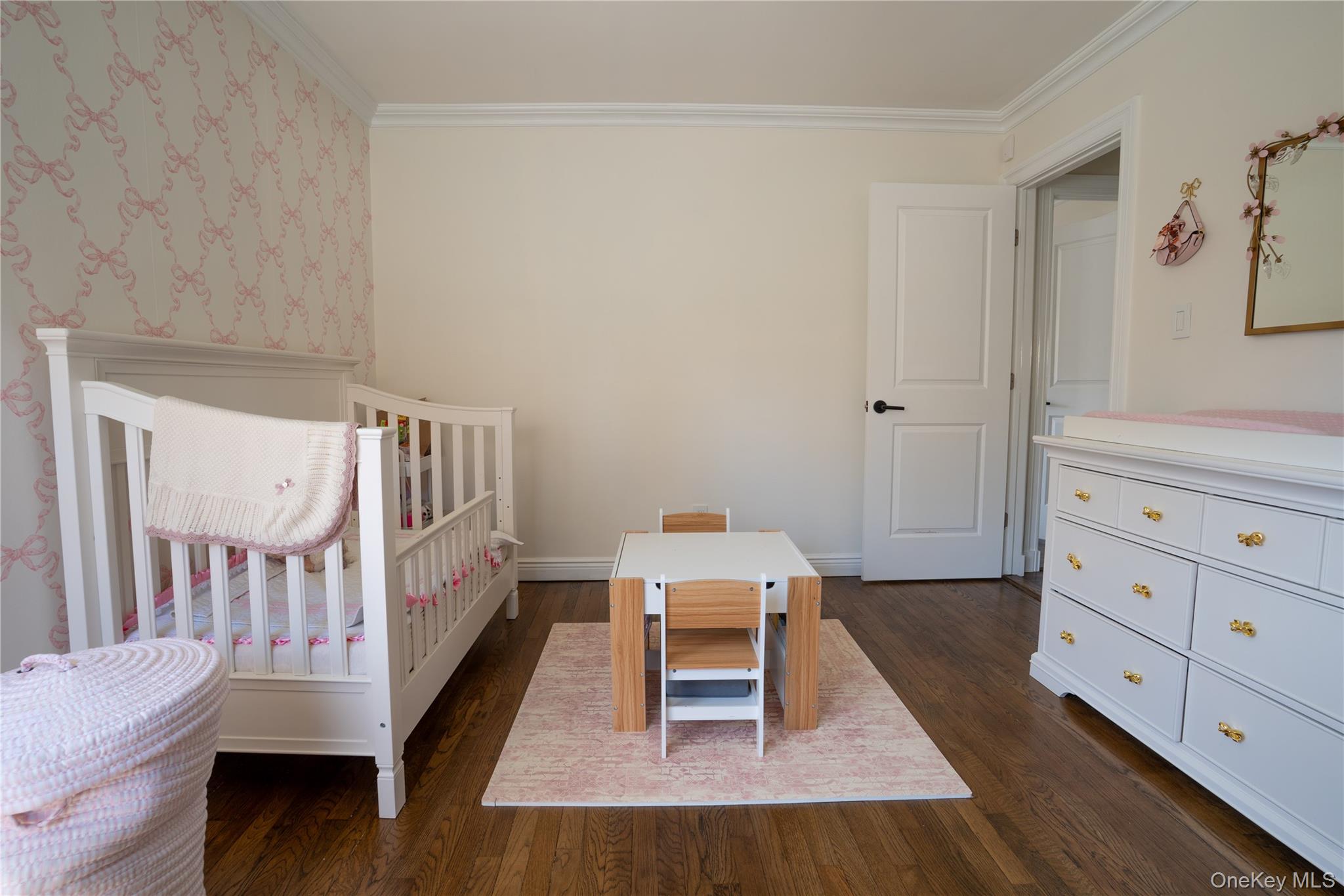 222-36 41st Road Queens, NY 11361 - Photo 11 of 21 a living room with furniture and a baby crib