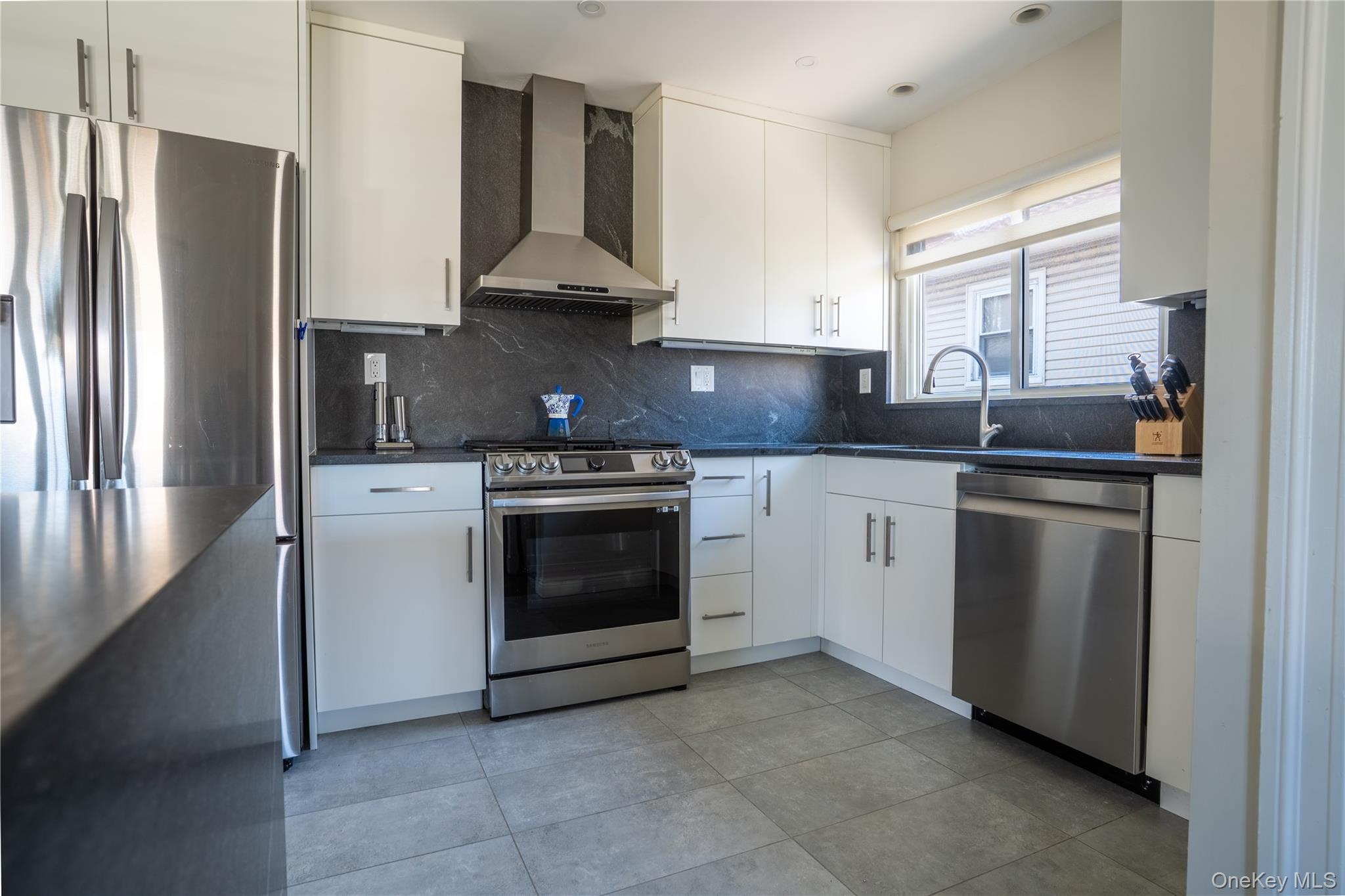 222-36 41st Road Queens, NY 11361 - Photo 7 of 21 a kitchen with stainless steel appliances a stove sink and refrigerator