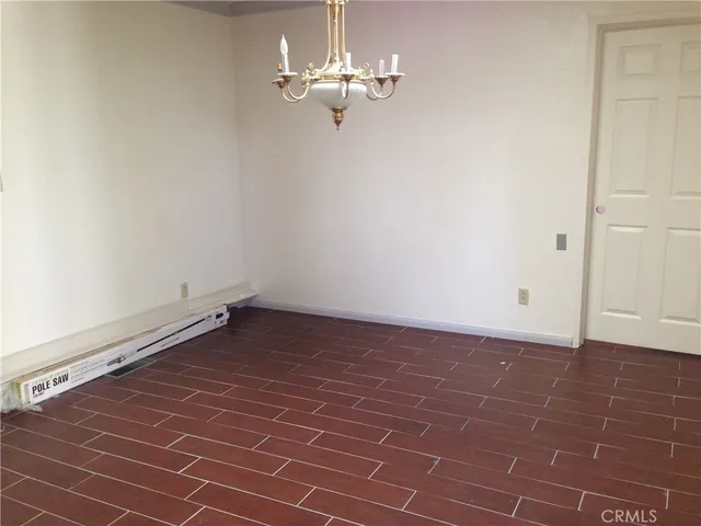 a view of a chandelier fan and wooden floor