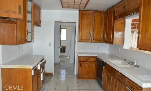 a kitchen with a sink and a refrigerator