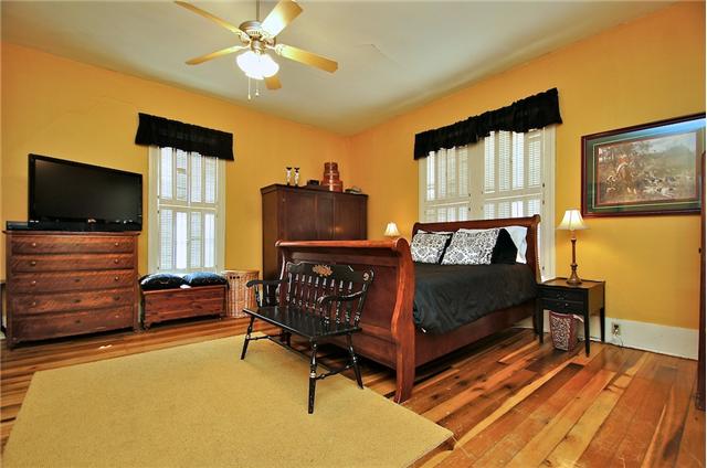 Cozy master bedroom, gleaming hardwood floors, plantation shutters, 
