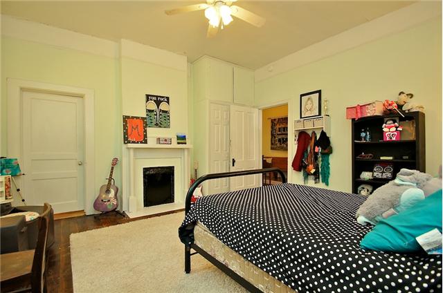 2nd bedroom with hardwood floors, high ceiling and old fireplace. 