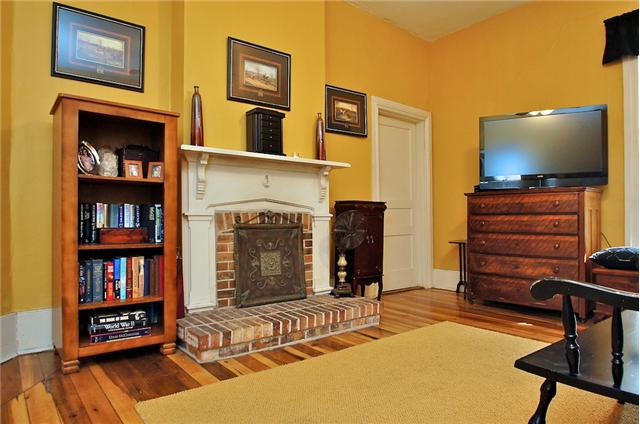 Master bedroom has old brick fireplace