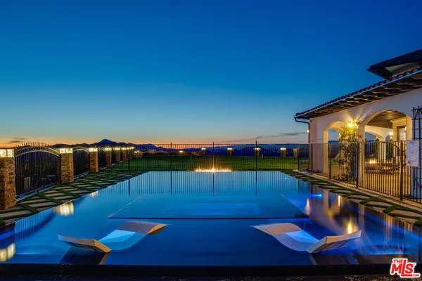 a view of swimming pool with outdoor seating