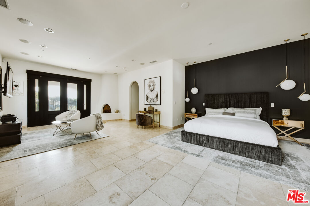 24573 Piuma Road Malibu, CA 90265 - Photo 11 of 30 a spacious bedroom with a bed and glass door