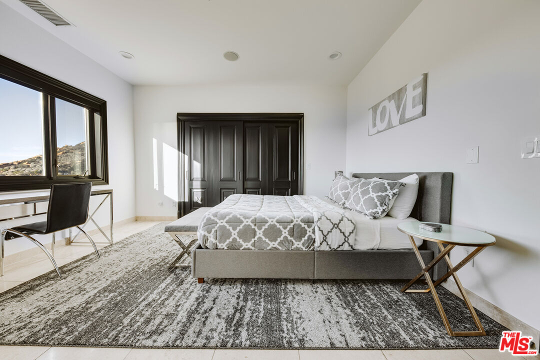 24573 Piuma Road Malibu, CA 90265 - Photo 14 of 30 a bed sitting in a bedroom next to a window