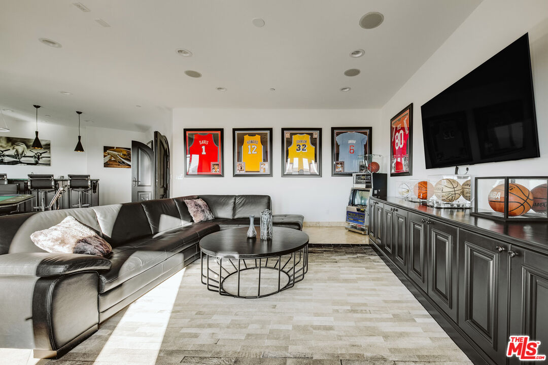 24573 Piuma Road Malibu, CA 90265 - Photo 15 of 30 a living room with furniture and a flat screen tv