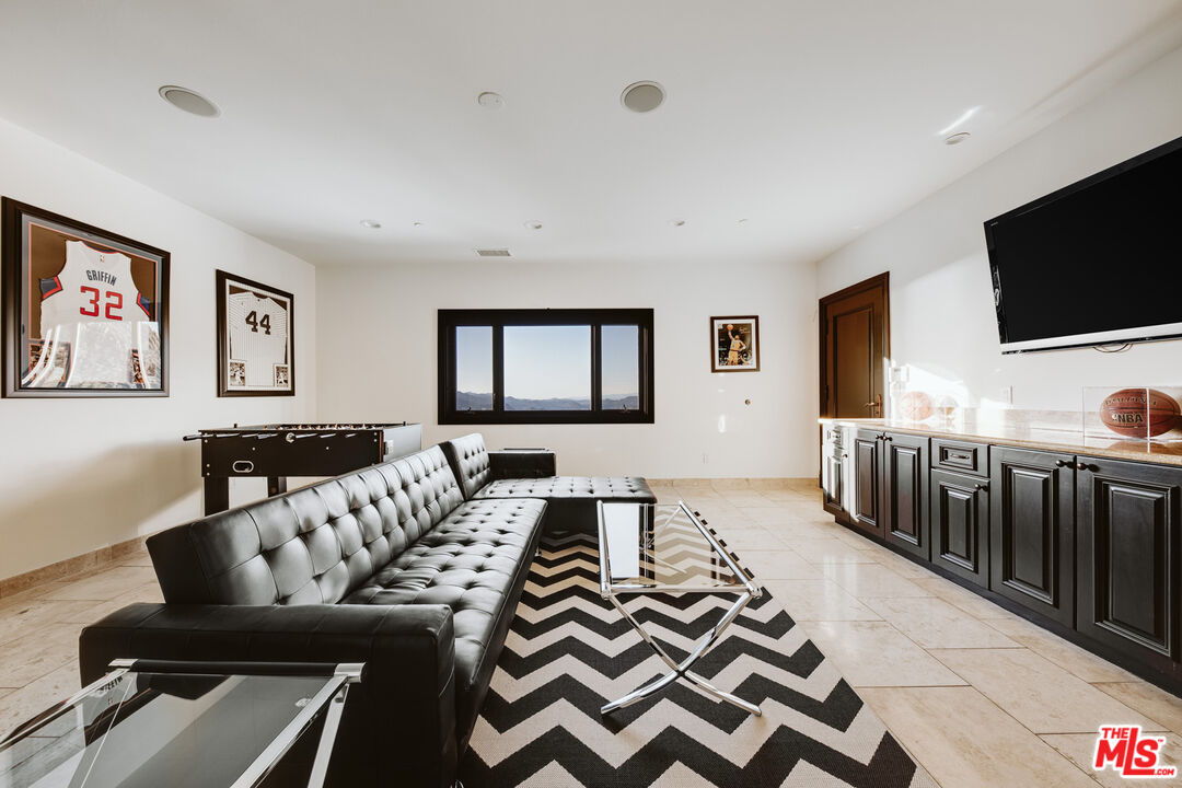 24573 Piuma Road Malibu, CA 90265 - Photo 17 of 30 a living room with furniture and a flat screen tv