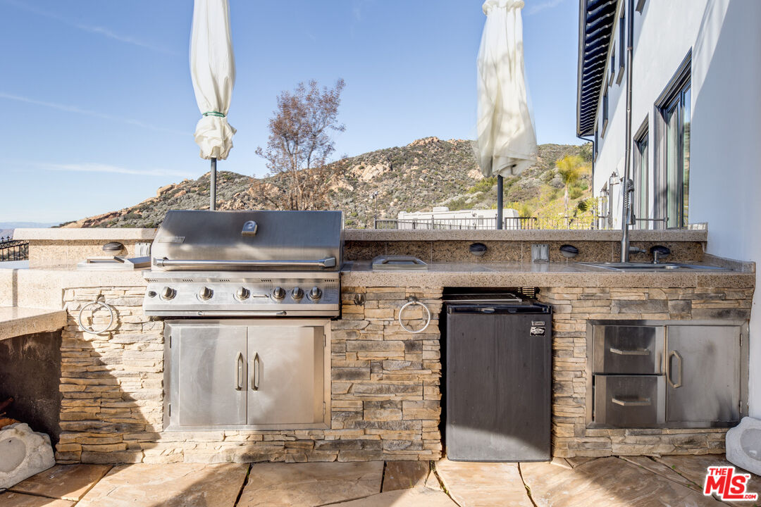 24573 Piuma Road Malibu, CA 90265 - Photo 20 of 30 a stove top oven sitting inside of a kitchen