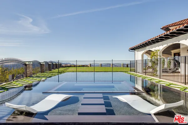 a view of a swimming pool with a lounge chairs