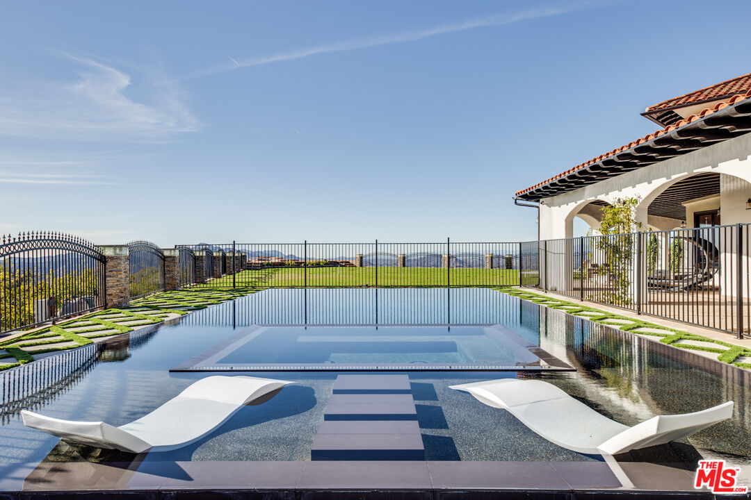 24573 Piuma Road Malibu, CA 90265 - Photo 21 of 30 a view of a swimming pool with a lounge chairs