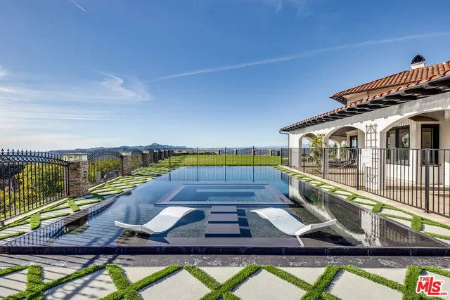 a view of swimming pool with seating space
