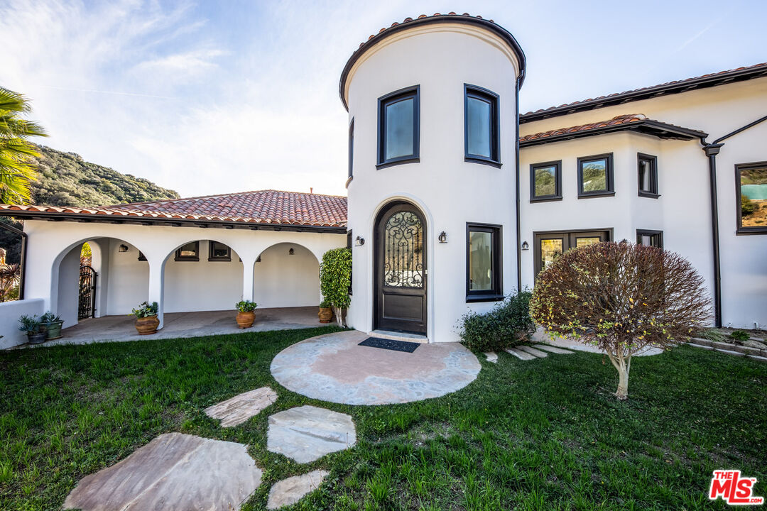 24573 Piuma Road Malibu, CA 90265 - Photo 25 of 30 a front view of a house with garden