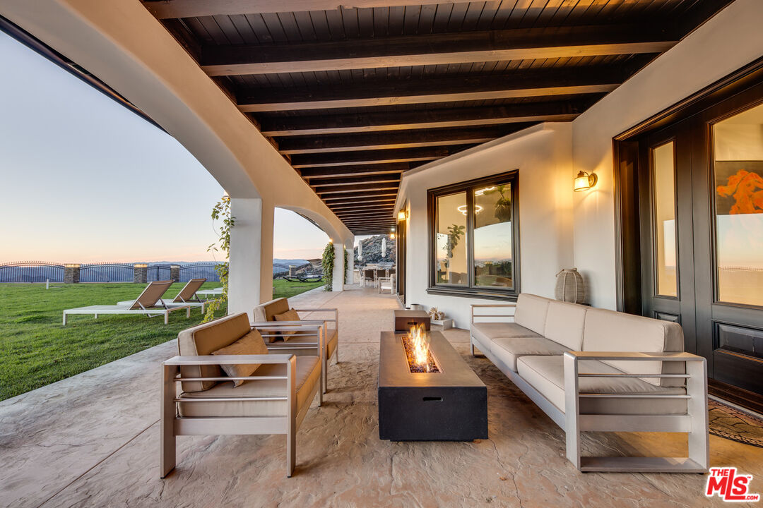 24573 Piuma Road Malibu, CA 90265 - Photo 26 of 30 a outdoor space with patio the couches and a dining table with garden view
