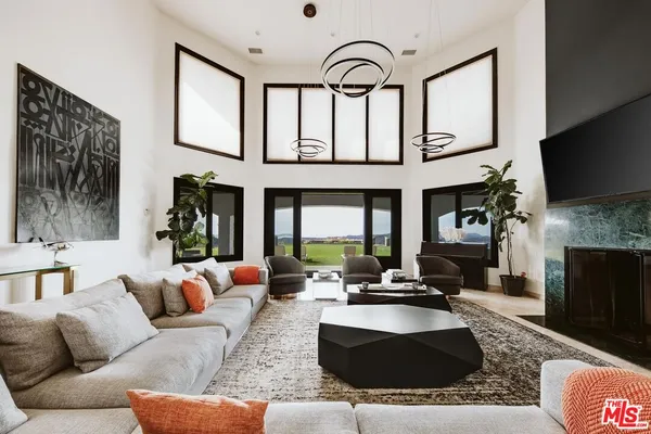 a living room with furniture fireplace and flat screen tv