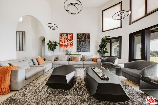 a living room with furniture rug and window