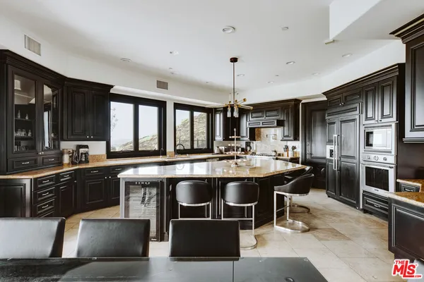 a kitchen with stainless steel appliances granite countertop a sink and stove