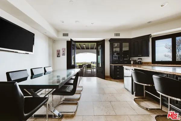 a kitchen with a dining table and chairs