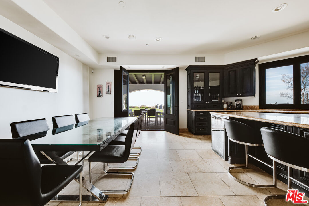 24573 Piuma Road Malibu, CA 90265 - Photo 9 of 30 a kitchen with a dining table and chairs