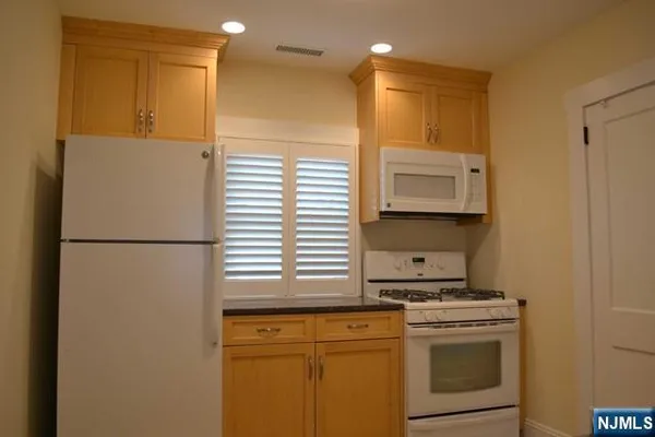 a kitchen with a stove cabinets and refrigerator