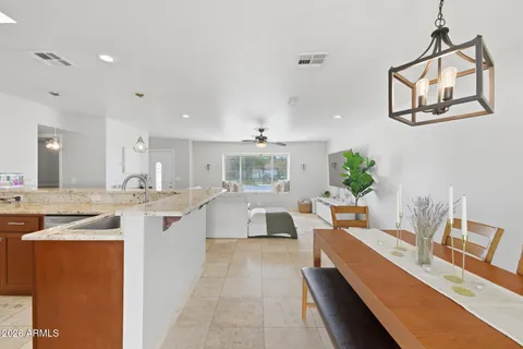 a large white kitchen with a large island