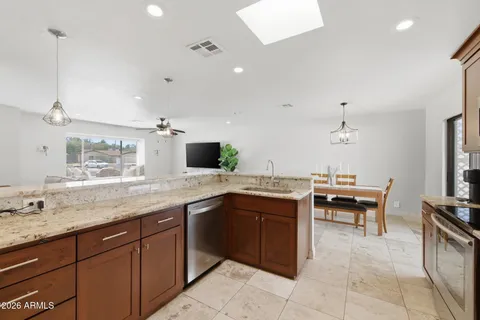 a kitchen with a sink and chairs