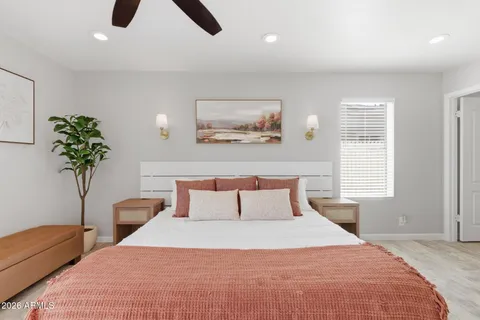 a bedroom with a bed and a potted plant