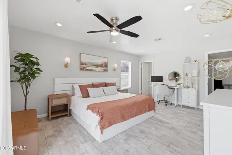 a bedroom with a bed and ceiling fan