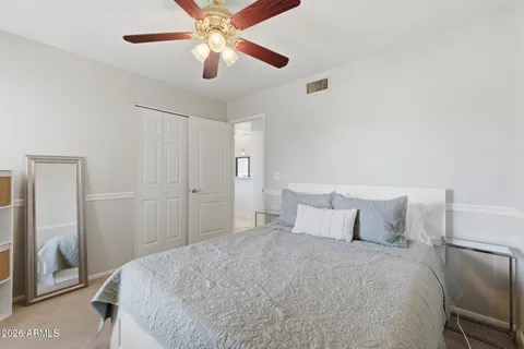 a bedroom with a large bed and a chandelier
